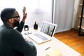 A guy talking online with employees via video call