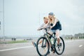 Guy teach his girl to ride a bike