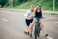 Guy teach his girl to ride a bike Royalty Free Stock Photo