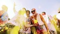 A guy throws yellow powder in the air at holi colour festival in slow motion