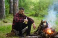 Guy with tired face and lonely at picnic, barbecue. Royalty Free Stock Photo