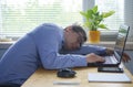 Tired of hard work student guy sleeping on laptop at table Royalty Free Stock Photo