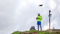 Guy tourist launches quadrocopter in the mountains Royalty Free Stock Photo