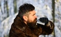 Guy with trees covered by snow on background. Brutal gamekeeper.