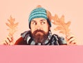 Guy with tricky face wears warm hat on pink background