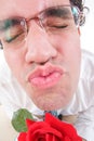 Guy trying to be romantic giving a kiss holding rose