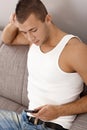 Guy in undershirt texting Royalty Free Stock Photo