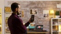 Guy uses his smart light application to turn on the light bulbs in the house Royalty Free Stock Photo