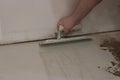 guy using a tool to smooth concrete over subflooring