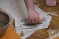 guy using a tool to smooth concrete over subflooring