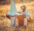 Guy in vintage clothes pilot with an airplane model outdoors Royalty Free Stock Photo