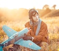 Guy in vintage clothes pilot with an airplane model outdoors Royalty Free Stock Photo