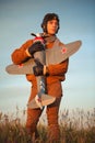 Guy in vintage clothes pilot with an airplane model outdoors Royalty Free Stock Photo