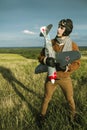 Guy in vintage clothes pilot with an airplane model outdoors Royalty Free Stock Photo