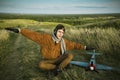 Guy in vintage clothes pilot with an airplane model outdoors Royalty Free Stock Photo