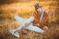 Guy in vintage clothes pilot with an airplane model outdoors Royalty Free Stock Photo