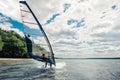 The guy in the waggon swims on the windsurf on lake Royalty Free Stock Photo