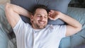 Guy Waking Stretching Hands Lying In Bed, View From Above