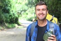 Guy walking in the jungle with water canteen