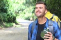 Guy walking in the jungle with water canteen