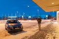 A guy in warm winter clothes on a winter morning walks on the street