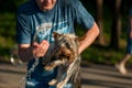 The guy washes the dog with cold water