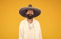 guy wear poncho. sombrero party man. man in mexican sombrero hat. vacation concept at resort in mexico. hipster with Royalty Free Stock Photo