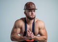 guy wear worker uniform. athletic builder in helmet. sexy man with body muscles. professional constructor or mechanic Royalty Free Stock Photo