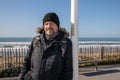 guy winter day portrait of beard middle age man handsome with wool hat in sea beach coast Royalty Free Stock Photo