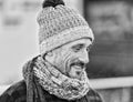 Guy in winter hat and scarf. Portrait of smiling man on street in black and white Royalty Free Stock Photo