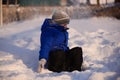 Child in winter clothes outside the city on the background of a Royalty Free Stock Photo