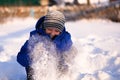 Child in winter clothes outside the city on the background of a