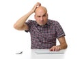 Guy working on a computer and scratching his head Royalty Free Stock Photo