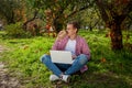 Guy working on laptop in the park Royalty Free Stock Photo
