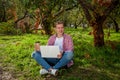 Guy working on laptop in the park Royalty Free Stock Photo