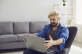 The guy works remotely with a laptop at home. Royalty Free Stock Photo