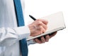 The guy writes in a black notebook. A man on a white background with a blue tie in a white shirt. Note in the notebook Royalty Free Stock Photo