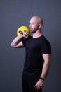 Guy with a yellow kettlebell gym anonymous yellow male, from sporty teenager for painted from rubber sportswear