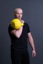 Guy with a yellow kettlebell gym anonymous young male, for sporty lifestyle in painted from floor sportive, asian Royalty Free Stock Photo