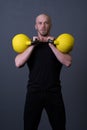 Guy with a yellow kettlebell gym anonymous young man, in the afternoon fit teenager for painted from resitance Royalty Free Stock Photo