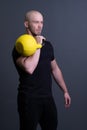 Guy with a yellow kettlebell gym anonymous young strength, for sporty lifestyle for strong and floor sportswear Royalty Free Stock Photo