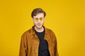 guy with yellow sunglasses posing on a yellow background