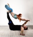 Guy and young woman doing strength exercises in yoga assanes. Acroyoga concept