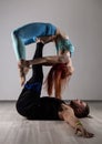 Guy and young woman doing strength exercises in yoga assanes. Acroyoga concept Royalty Free Stock Photo