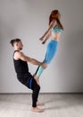 Guy and young woman doing strength exercises in yoga assanes. Acroyoga concept Royalty Free Stock Photo