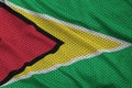 Guyana flag printed on a polyester nylon sportswear mesh fabric Royalty Free Stock Photo