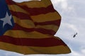 A spanish guardia civil helicopter seen near a catalan separatist independant flag in barcelona