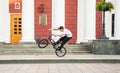 Guys cycling in the town square. Without a helmet