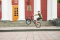 Guys cycling in the town square. Without a helmet