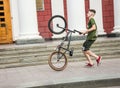 Guys cycling in the town square. Without a helmet